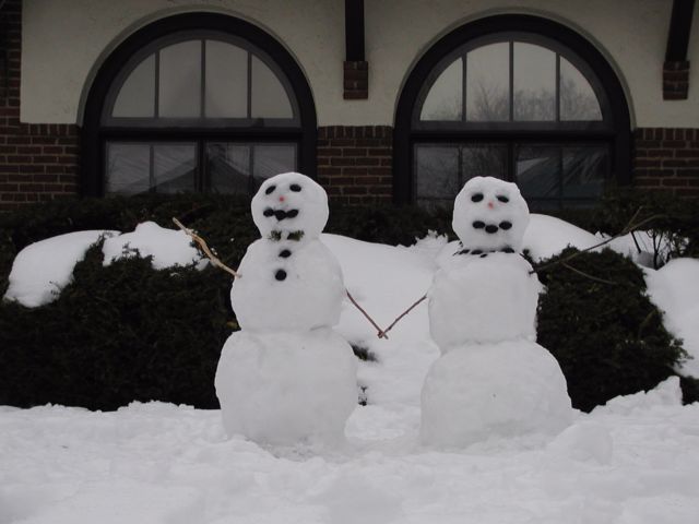 Picture Snowman and Snowwoman holding hands in front of number 24 school on Meigs St Happy Valentines Day Rochester NY February 14th 2003 POD winter Picture Of The Day view picture photo image picture pictures photos images