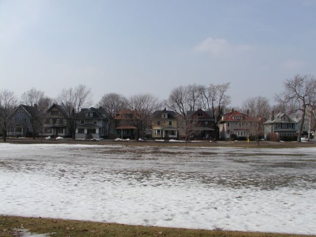 Picture Snow and ice melt away soaking the earth that will soon flourish with green lawn at the lower section of Cobbs Hill Park. Eight of the homes along Culver Rd that enjoy a picture perfect view fill the background. Rochester NY March 19th 2003 POD winter Picture Of The Day view picture photo image picture pictures photos images