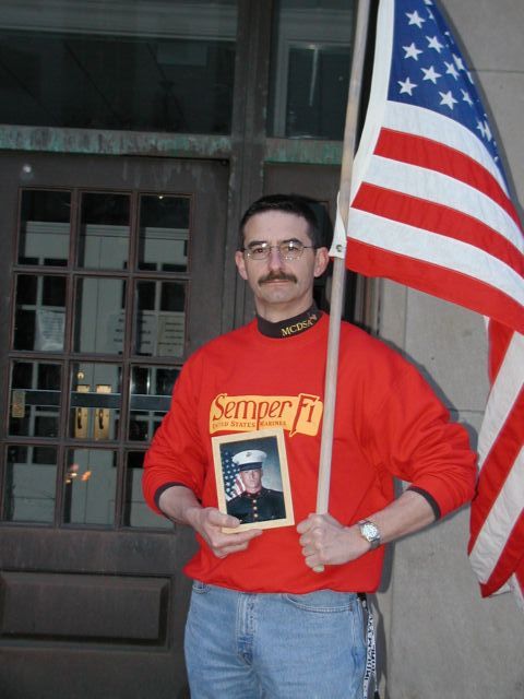 Picture Semper Fi One day, one city, three rallies.  There were two war rallies held in Rochester NY on March 28th, one to support the troops, the other to denounce the war, the current administartion, and other issues.  This gentleman held a one man rally as a greeting to the anti-war marchers when they returned to the Liberty Pole at the end of their march.  There are 45 photos of the days events located at RocPic.Com Rochester NY New York March 31st 2003 POD spring Picture Of The Day view picture photo image picture pictures photos images