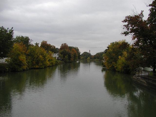 Picture Looking West from the Lift bridge over the Erie Canal Fairport NY New York, Fall, October 2002, Trees with leaves colored green, red, yellow and gold, line both sides of the Erie Canal. RocPic.Com Rochester NY New York Picture Of The Day 
