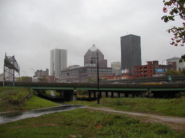 Photo Skyline Rochester NY New York view from east bank of Genesse River looking north trees display Fall colors Hyatt Hotel, Lincoln Tower, Bausch & Lomb, Midtown Plaza, Xerox, Blue Cross Blue Shield Buildings in view October 2002 Rochester NY New York