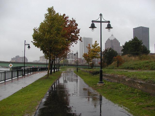 Skyline Photo Rochester NY New York Picture From East Bank of Genesee River Looking North On Paved Path Walking In The Rain, Lincoln Tower, Bausch & Lomb, Xerox Buildings In View Fall October 2002 Rochester NY New York Photo Todays Picture of Rochester NY New York Photos Pictures Image Images