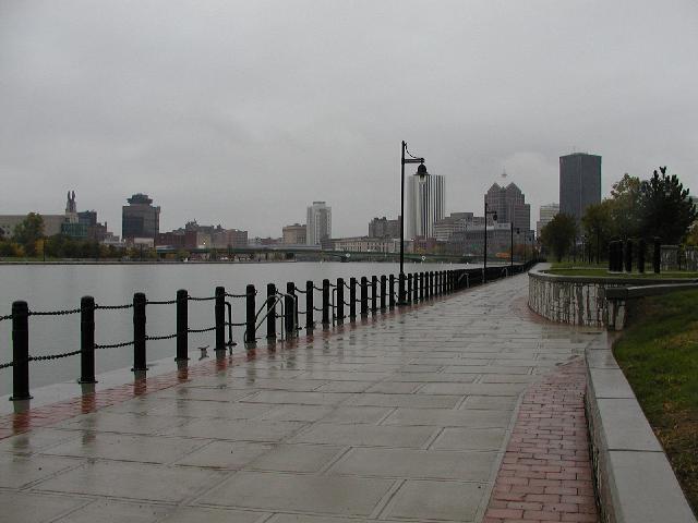 Rochester NY New York Photo Walk In Rain On Sidewalk Along East Bank Of Genesee River View Of Times Building Through Holiday Inn Hyatt Lincoln Tower Bausch & Lomb And Xerox  Buildings In View Fall October 2002 Rochester NY New York Photo Todays Picture of Rochester NY New York Photos Pictures Image Images