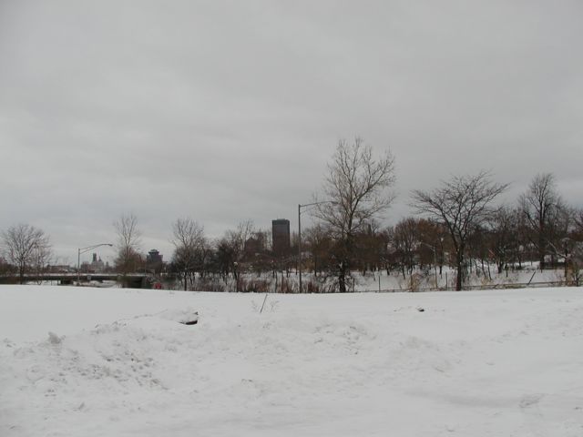 Picture Rochester NY New York fresh winter snow ground cover, cloud filled sky, downtown Rochester skyline, from South Goodman Street. December 27th 2002 POD Rochester NY New York Picture Of The Day December view picture photo image pictures photos images, December 27th 2002 POD