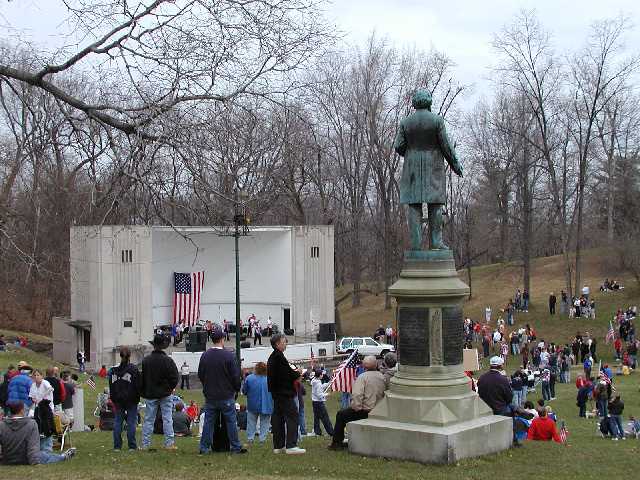 A statue of Frederic Douglas towers over the friends, families, and supporters of America,  and the American Armed Forces, at the WHAM hosted 'Rally Round America' April 19th 2003 Highland Bowl Rochester NY  Image 28 of 60  -  62 kB