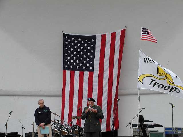 Army Chaplin, Father Elmer Heindl, One of the most decorated chaplains of WWII, leads the gathered audiance in prayer during the Rally 'Round America celebration held in Highland Park, Rochester NY, April 19th, 2003.  Image 38 of 60  -  29 kB