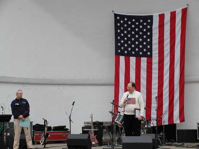 Monroe County Executive, Jack Doyle, Joins WHAM's Bill Lowe on the stage during the Rally 'Round America celebration April 19th, 2003, Highland Park, Rochester NY Image 39 of 60  -  28 kB