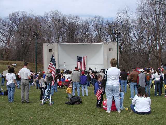 You are viewing American families, as they stand and listen to community leaders express pro America values that rarely make the news, yet reflect the beliefs held by more than 70% of the USA. You are looking at families who provide the sons and daughters that are at risk in defense of the USA, and in efforts to make a world secure from WMD. You are viewing Americans who are interested in peace in a manner that rarely makes news... Rally 'Round America, Highland Park, Rochester NY, April 19th, 2003. Image 57 of 60  -  53 kB